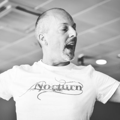 Black and white photo of John Darvell with NOCTURN tshirt on