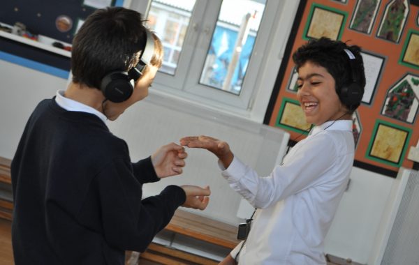 MidSummerland. Two children listen to the audio adventure in the school hall