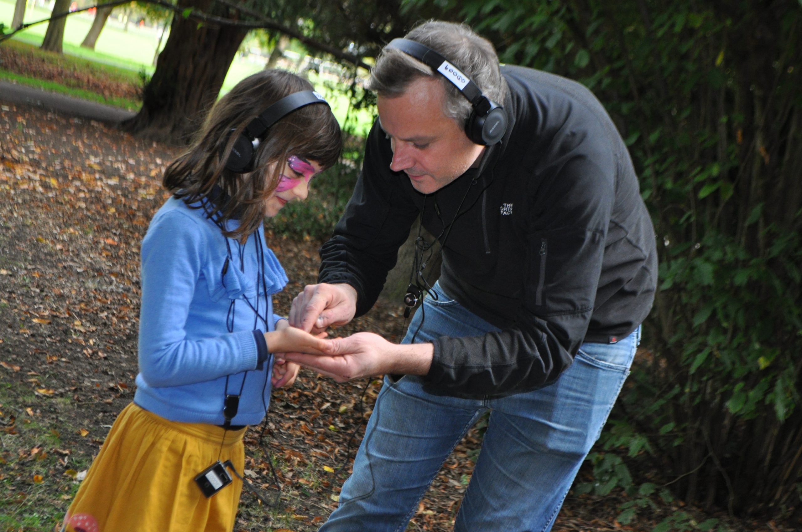 MidSummerland. A child and an adult wear headphones and prepare to press play at the same time